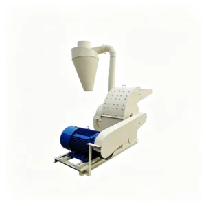 Stationary industrial wood grinder processing logs, branches, wood scraps, and biomass waste into fine particles for recycling